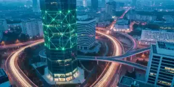 Aerial view of a city at dawn, a modern skyscraper emitting green light patterns symbolizing business insights, with intricate road networks representing data streams.