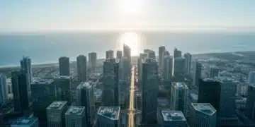Beyond the Horizon: Crafting Future-Forward Growth with Business Insights An aerial drone shot of a futuristic cityscape at dawn, with geometric green-accented skyscrapers and a path leading towards the ocean, symbolizing future-forward business insights and growth strategies.